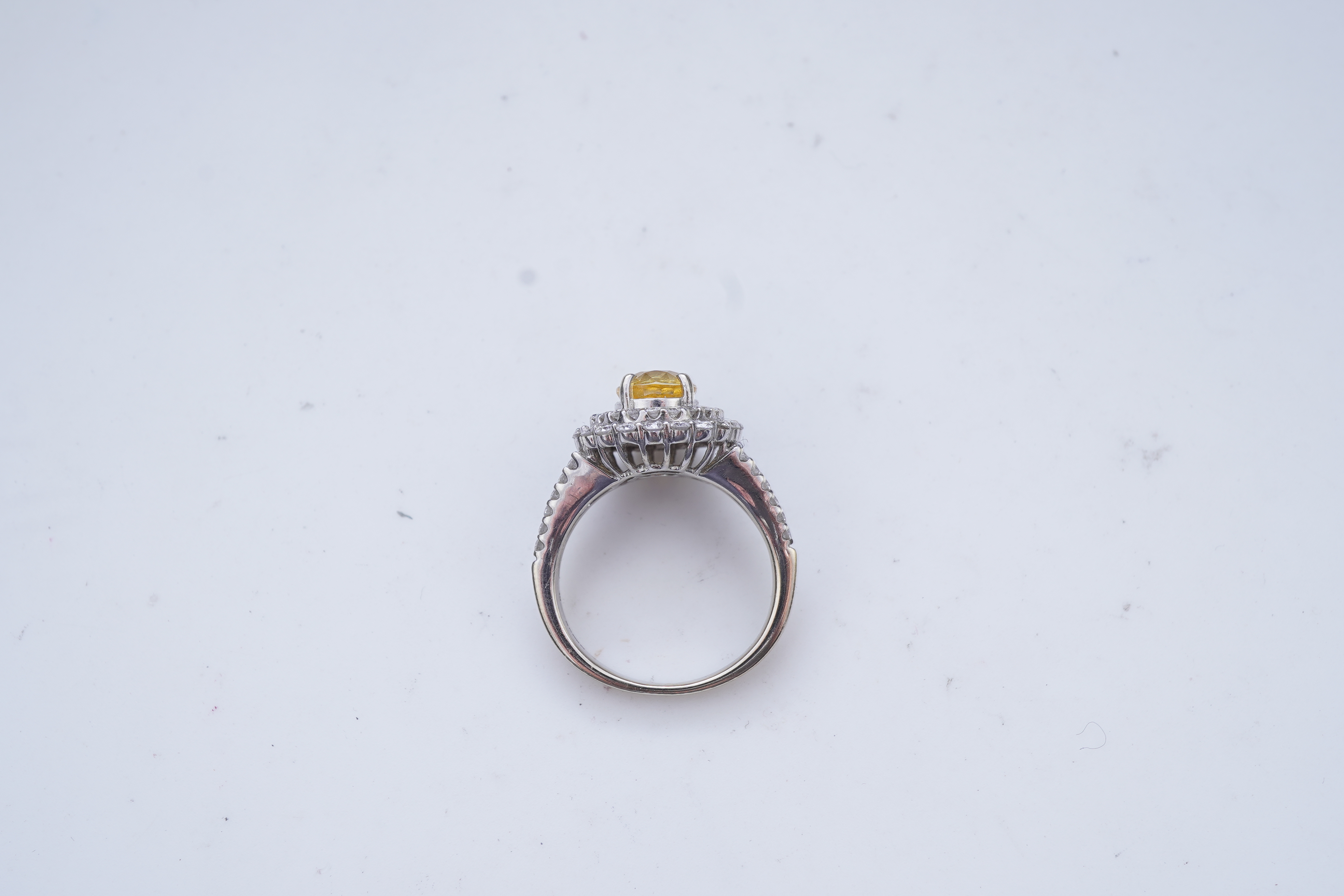 A yellow sapphire and diamond ring